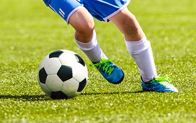 carrying the soccer ball down the field links to Sports Fitness and Athletics webpage